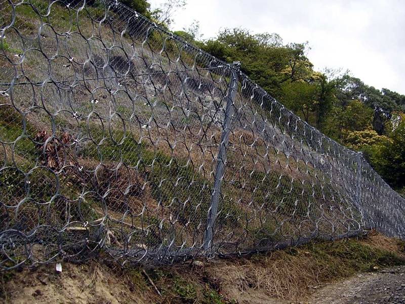 Steel ring net combined with chain link fence used to block the rocks.