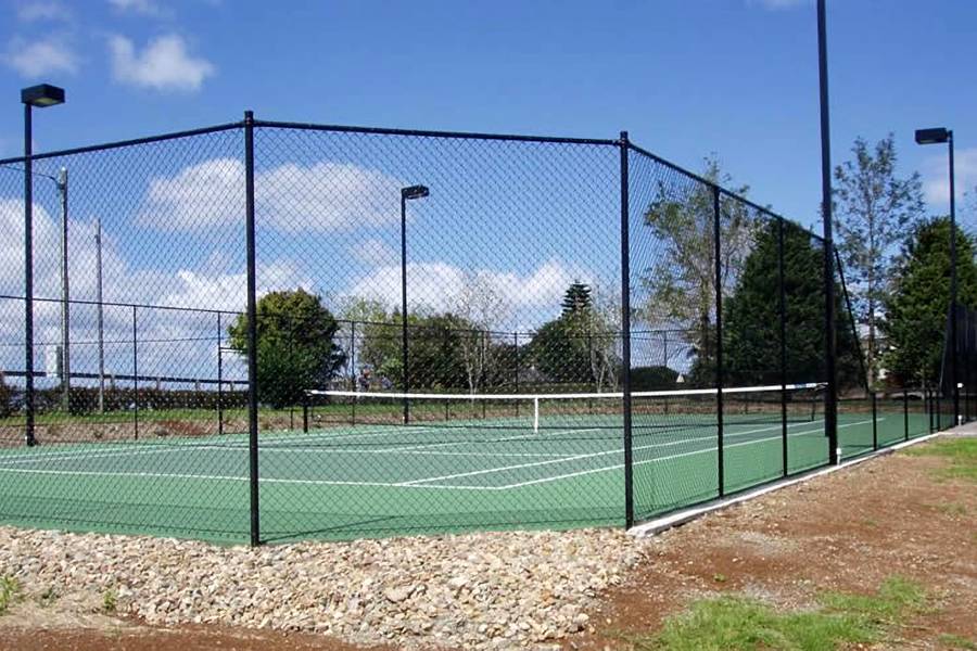 More than 3 meters high chain link fence circles tennis court.