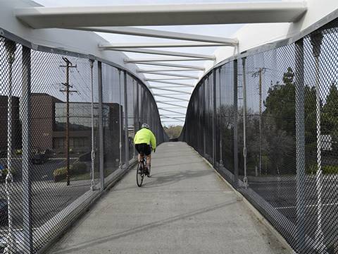 A passenger passage with very strength and durable chain link bridge railing in geometrical shape cross over roads.