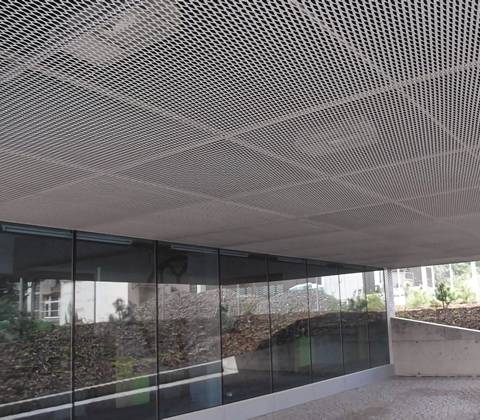 Expanded Mesh Ceiling In Office Administrative Building Lounge