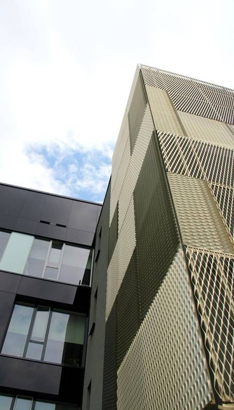A close-up picture of aluminium expanded metal ornamental facade with golden color.