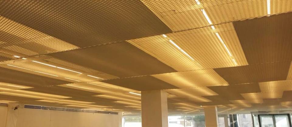 Brass expanded metal mesh ceiling.