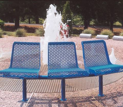 A linked but only for three men to sit expanded metal bench next to fountains.