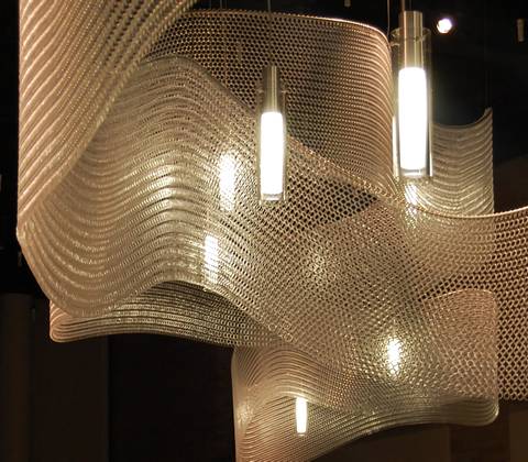 Wavy ring mesh around some lamps overhead.