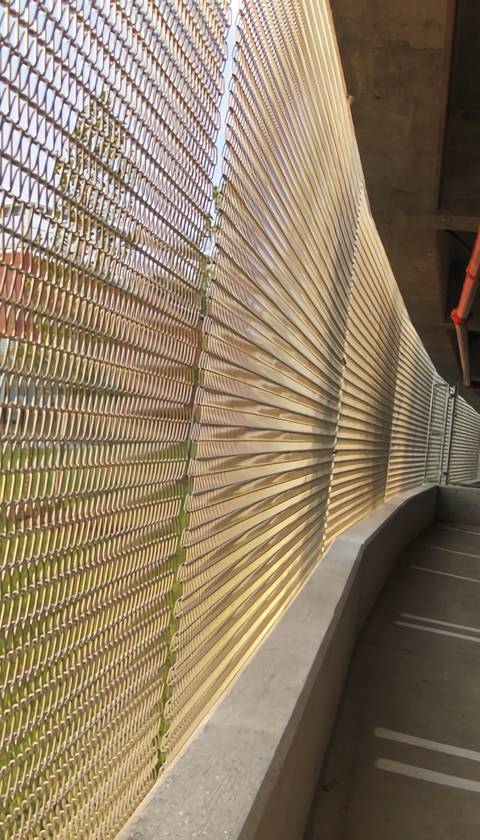 Long stretches of corridor spiral mesh building facade