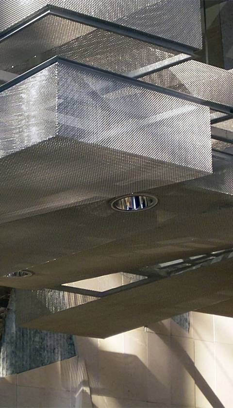 Stainless steel ring mesh mounted on uneven ceiling, presenting a feeling of pleasing.