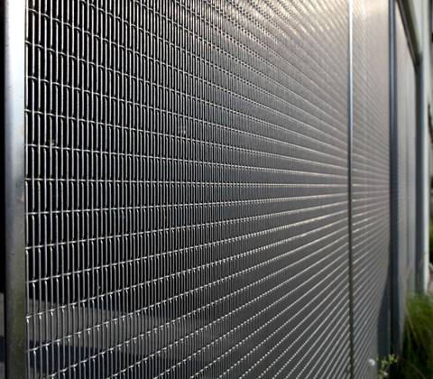A building is designed with metal crimped wire mesh facade.
