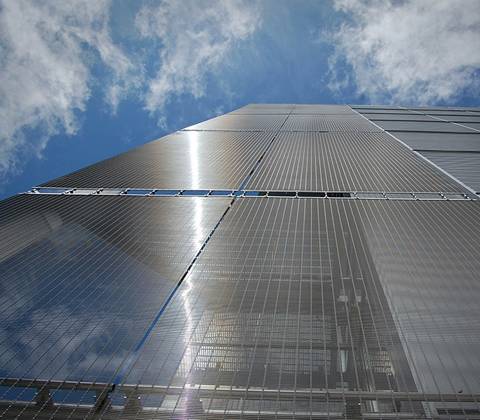 Four side of a tall building is enclosed by wire rope woven mesh.