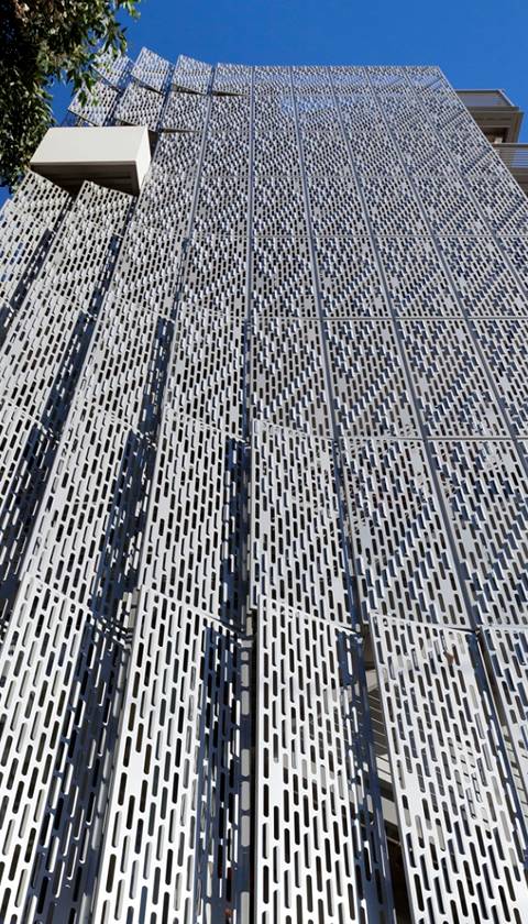 Perforated metal with rectangle shaped mesh opening for building facade.
