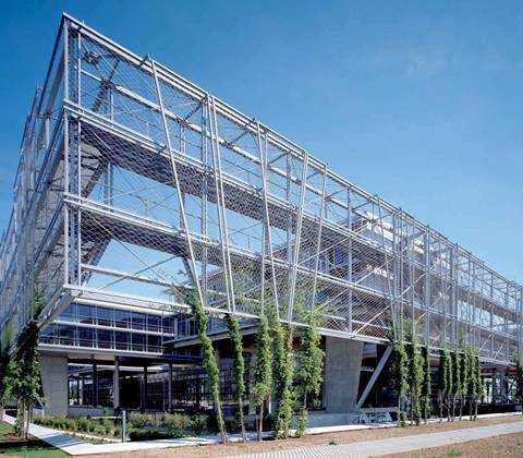 A modern and geometric frame building is protected by wire rope mesh.