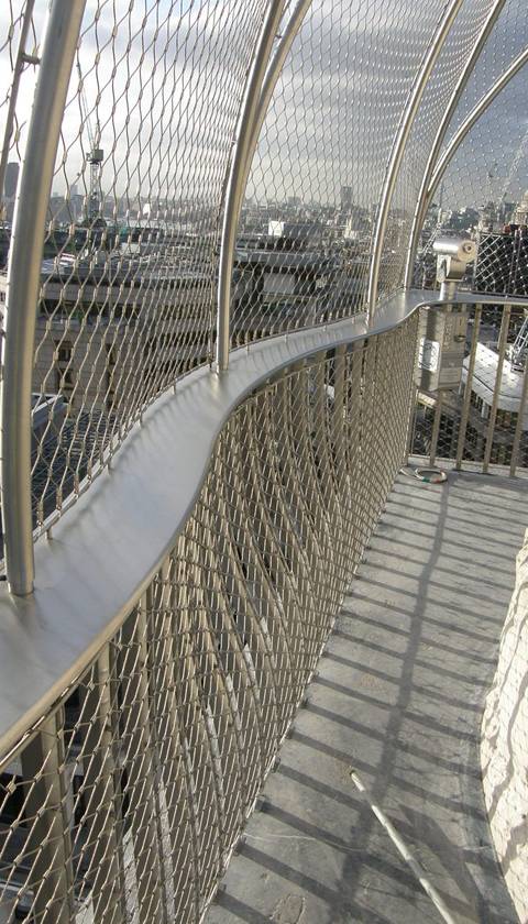 A viewing platform is enclosed by wire rope mesh.