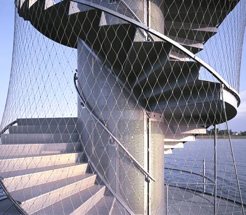 Durable wire rope mesh covers a spiral staircase and make it very novel.