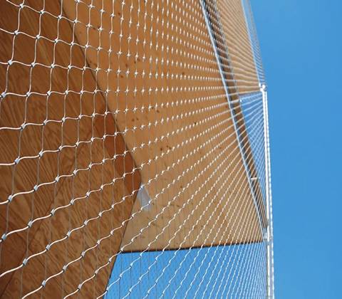 Stainless steel wire rope mesh covers on the outside of a building.
