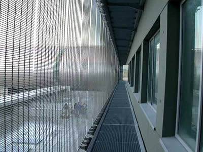 Decorative wire mesh is installed in a building.