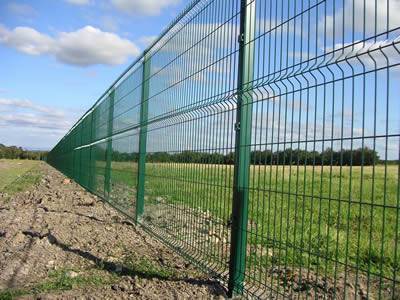 It shows welded wire mesh fence with green vinyl coated, assembled in the open air.