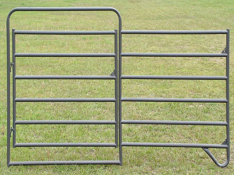 A horse fence gate on the grassland.