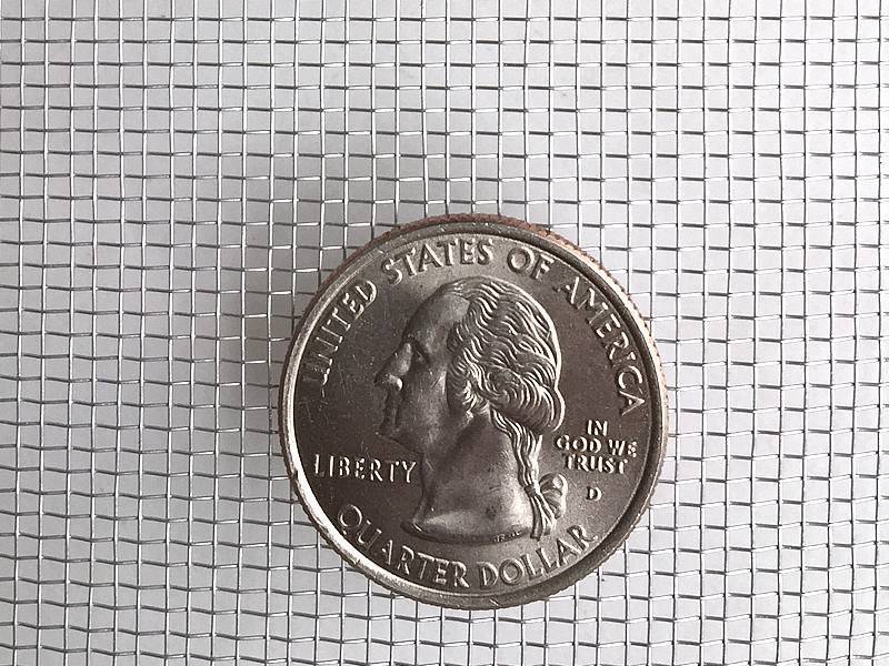This is one piece of aluminum woven wire mesh, with one coin shown to illustrate scale.