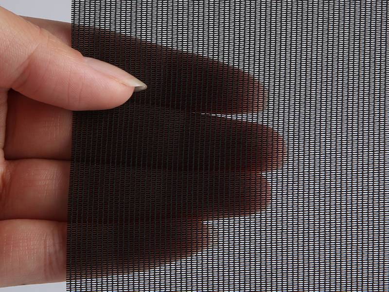 A piece of anti-pollen mesh screen sample hold by a hand.