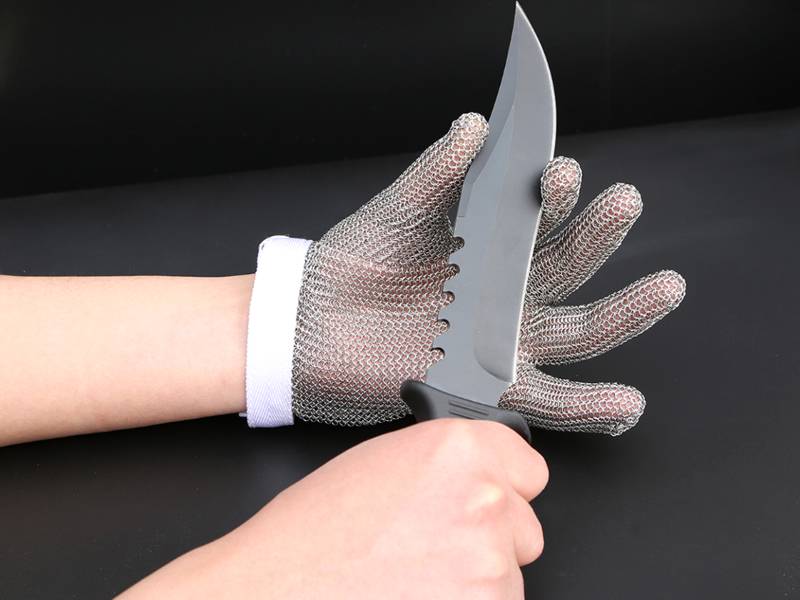 Holding a sharp knife with a chainmail gloves.