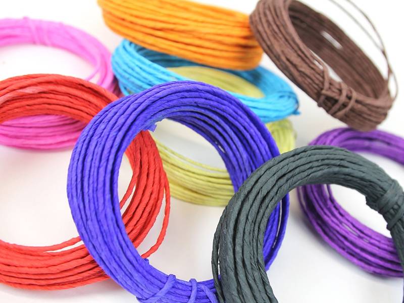 Nine coils of colorful paper covered craft copper wire for floral arrangement.