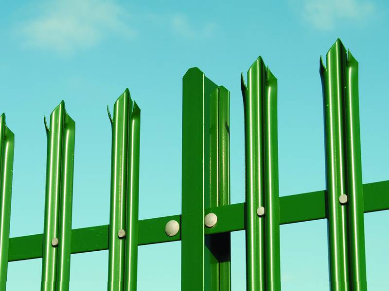 There is a green steel palisade fencing installed with pales of corrugated W section.