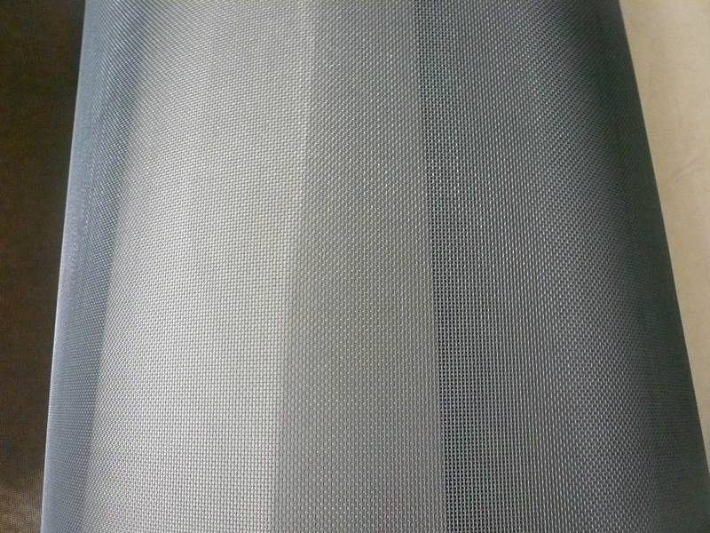 A roll of opening molybdenum woven wire mesh with silver gray color.