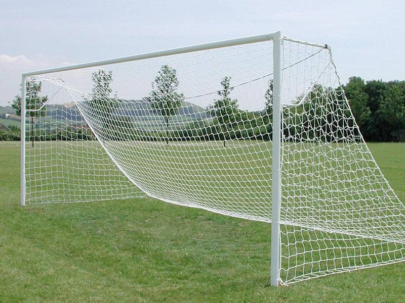 A football net is installed on frame on playground.