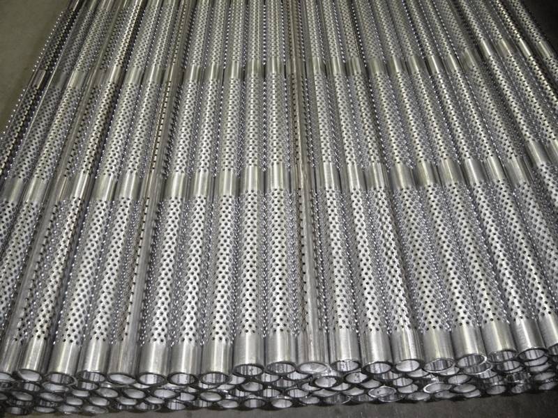 Many perforated casing pipes placed together orderly.