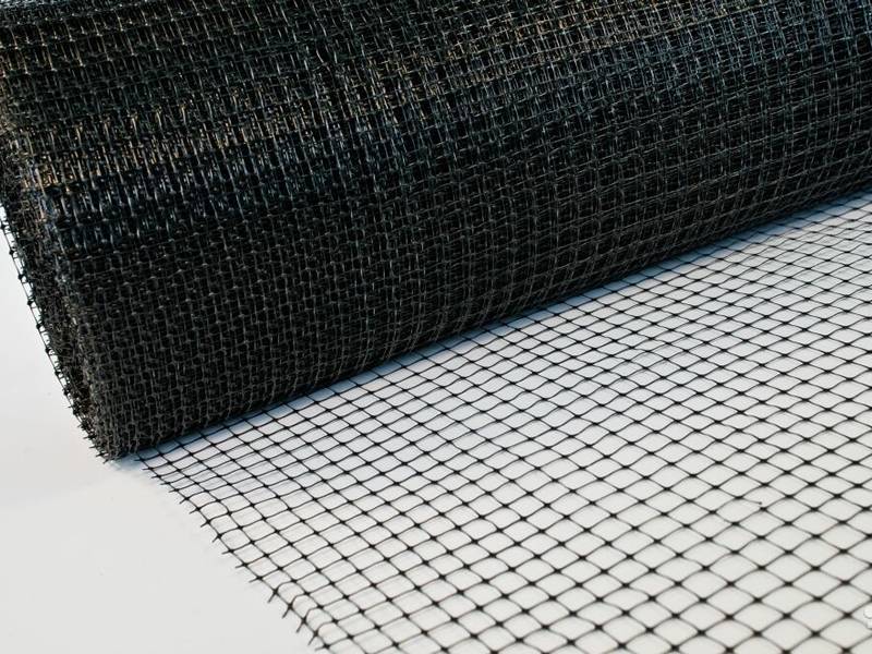 A black plastic plaster mesh in a roll.