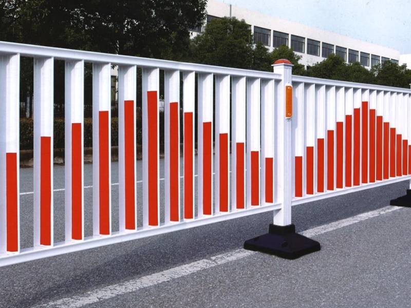 Two columns of flat top road fence with red color on the road.