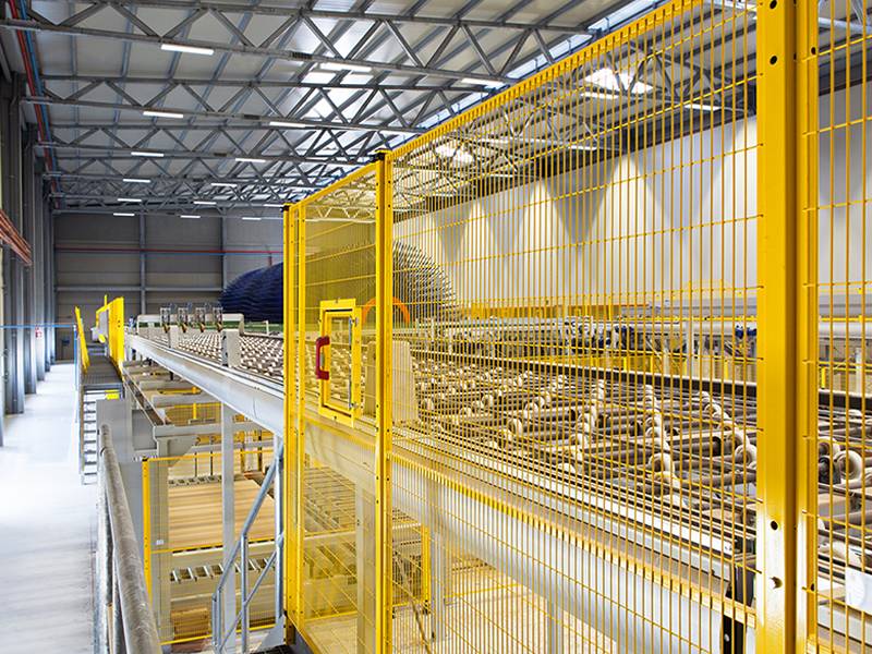 The yellow safety fence machine guarding is surrounding the production line.