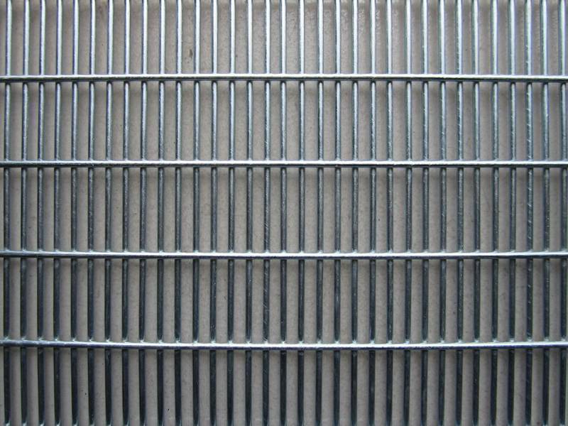 A piece of galvanized welded security fence panel.