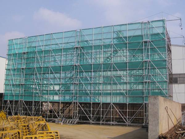 Protective measures such as scaffolds and safety nets used in the construction sites.